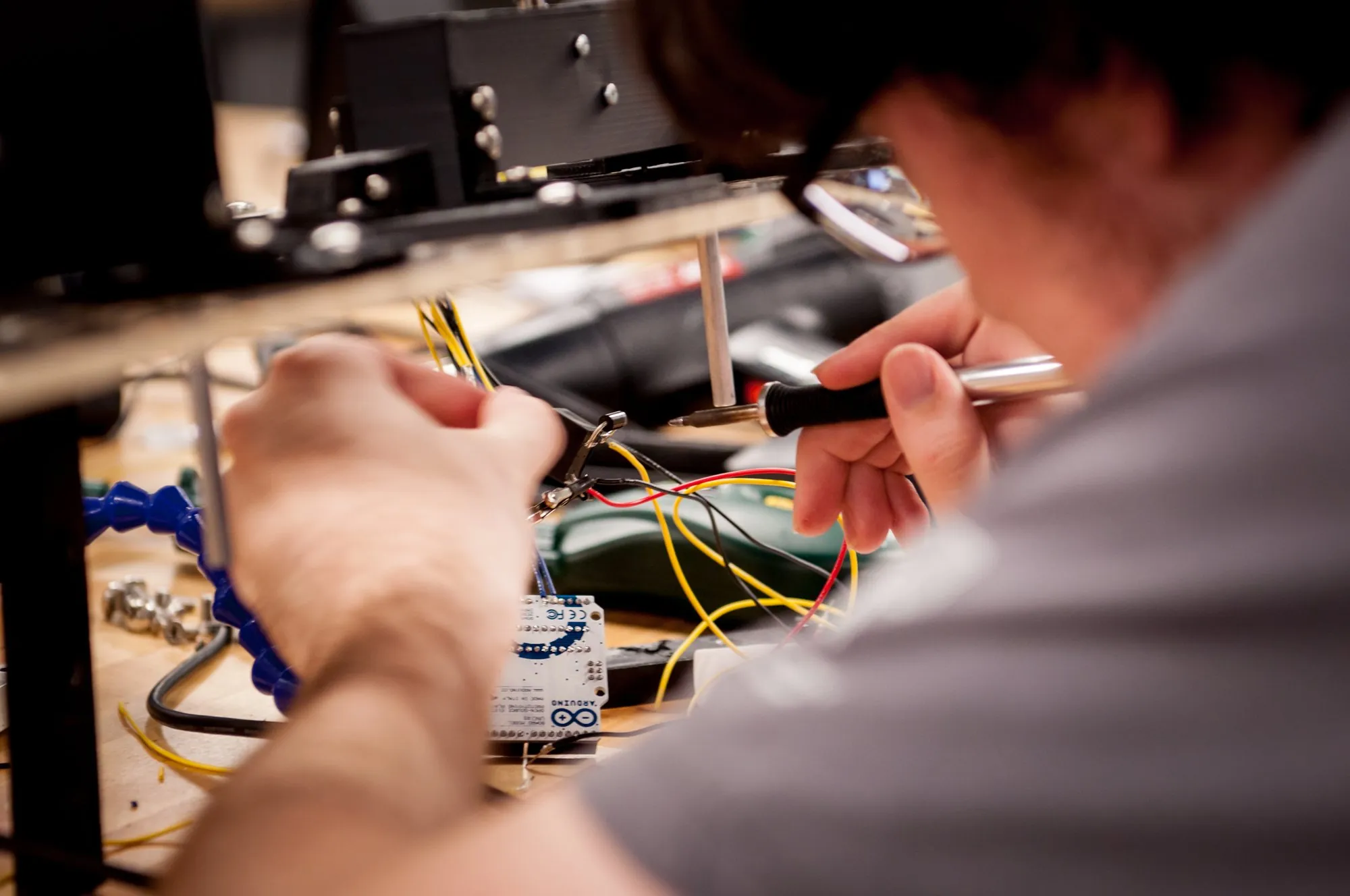 Engineer soldering a prototype board at Novus Labs