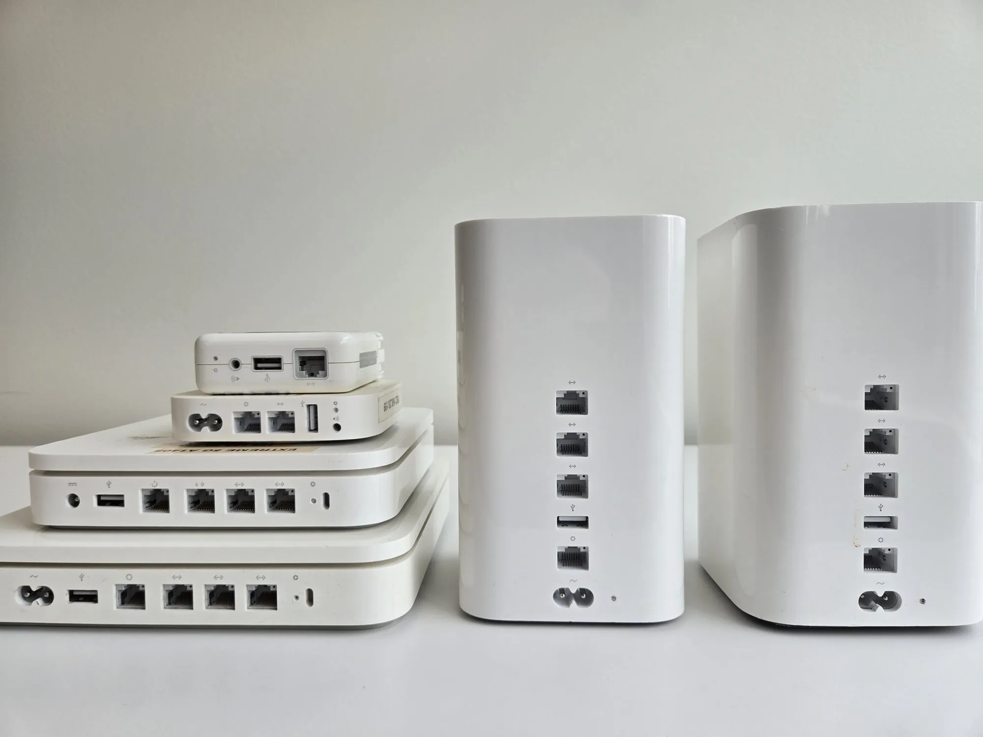 Side profile of the AirPort line showing the evolution from flat base stations to tall tower designs
