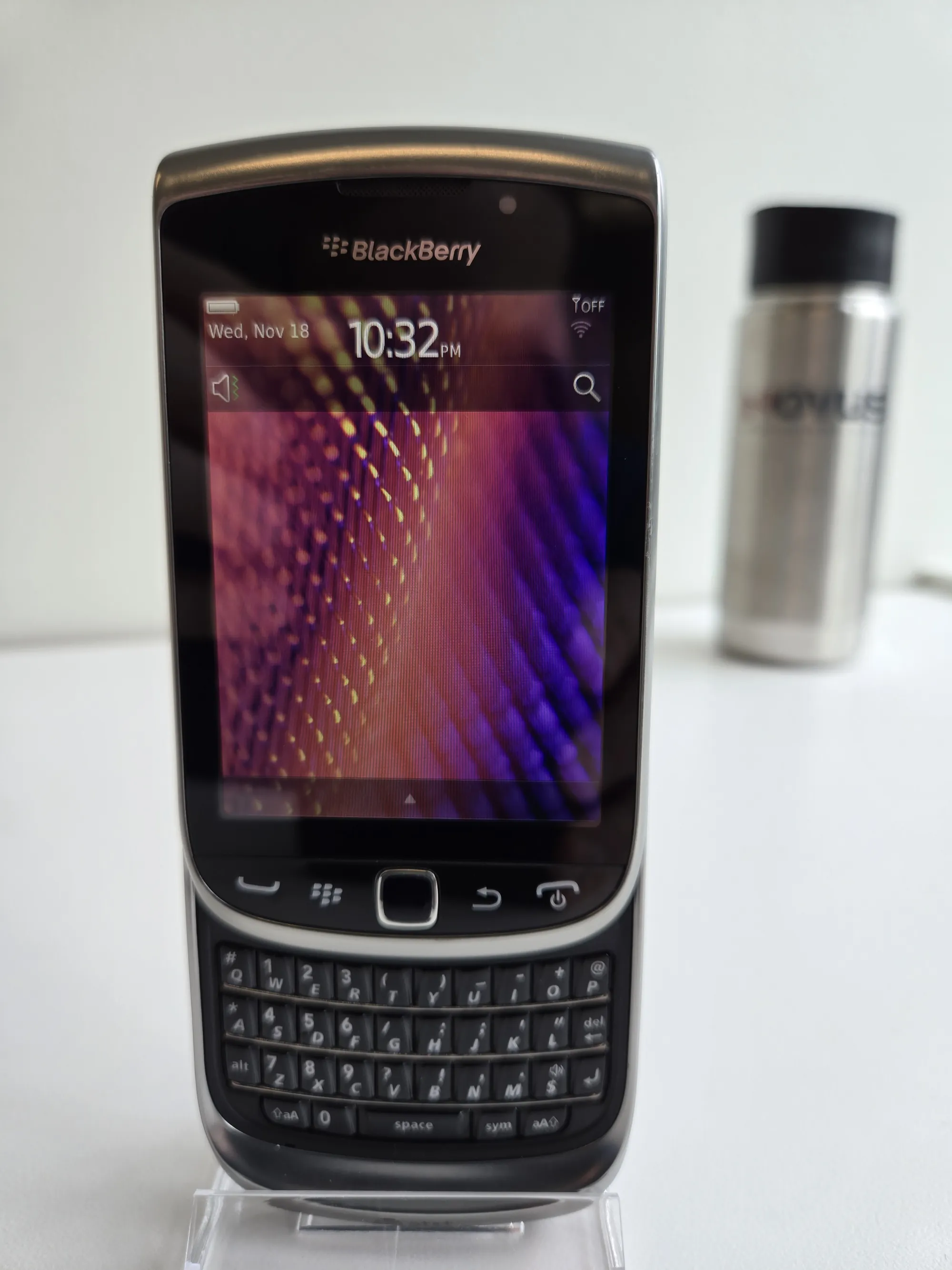 BlackBerry Torch 9810 with the slider open, revealing the physical QWERTY keyboard