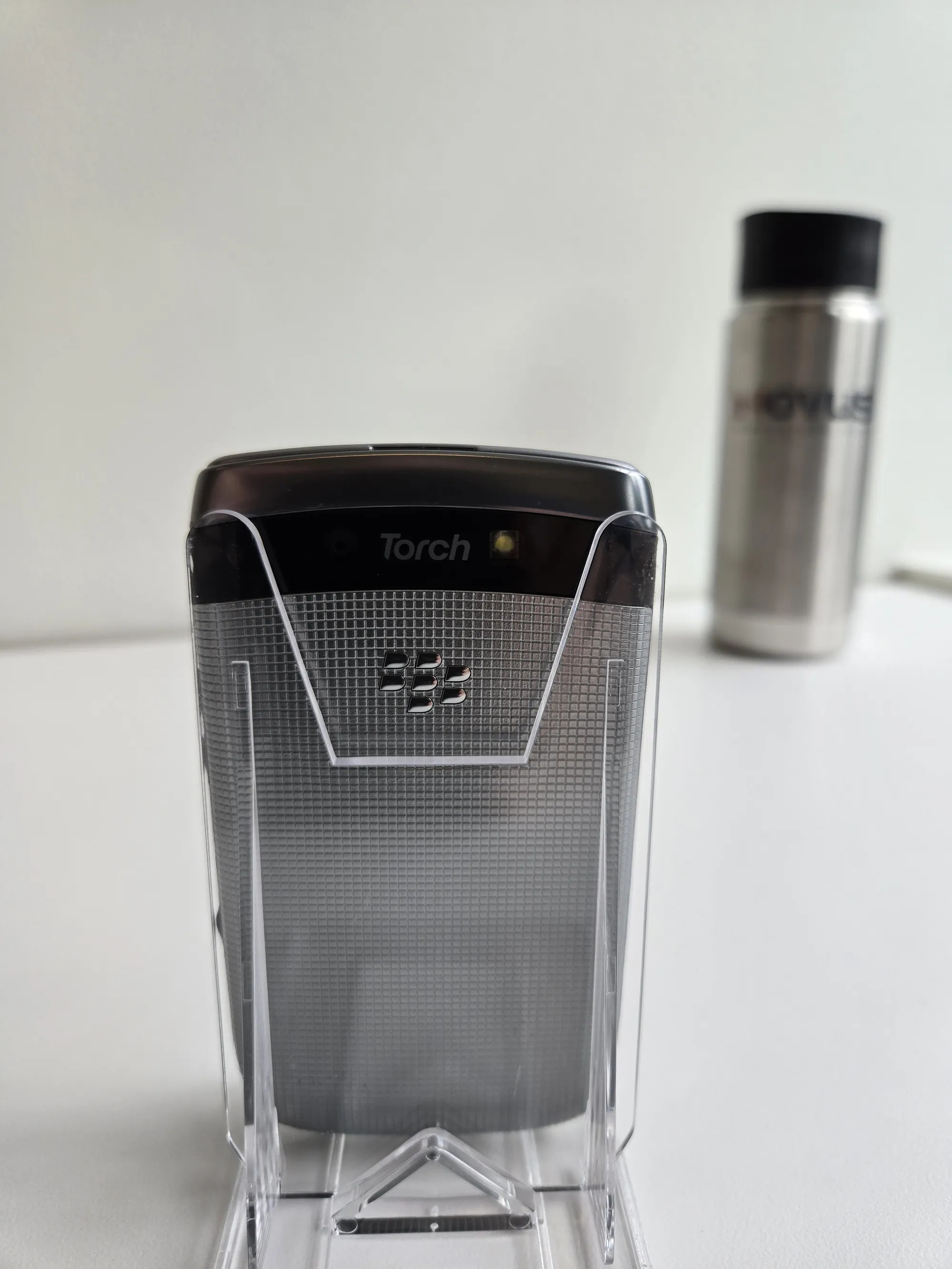 Back of the BlackBerry Torch 9810 showing the Torch branding and textured battery cover