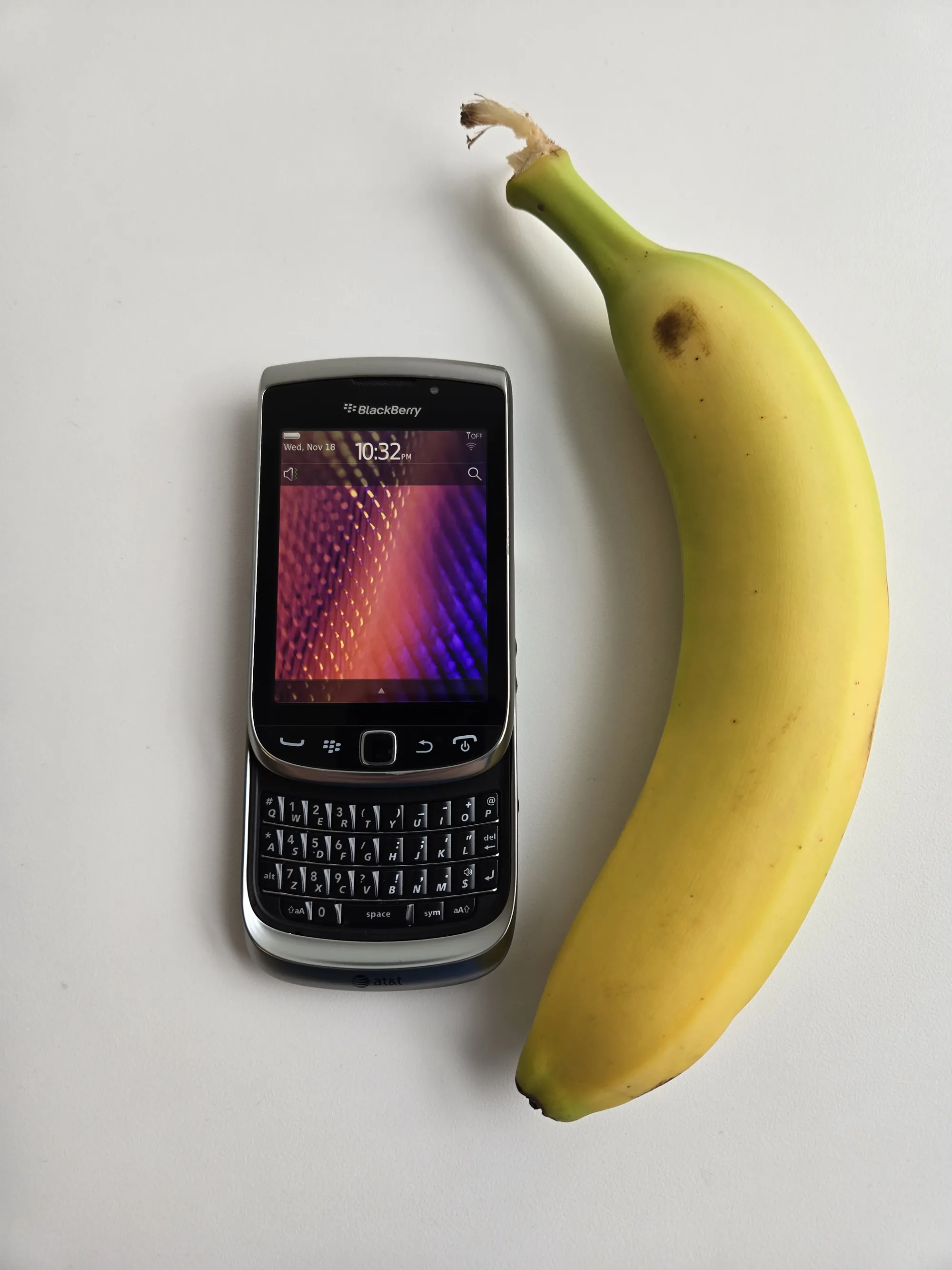 BlackBerry Torch 9810 shown next to a banana for scale, slider open