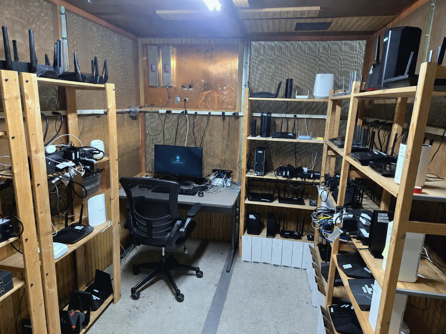 Shelves of networking devices in a Novus Labs automated device testbed
